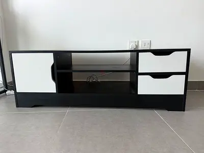 Low black TV cabinet with white drawers and storage