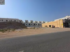 Commercial land for sale on Al Zubair Main Street, 10,000 sq ft, in a prime location in Al Yasmin ar