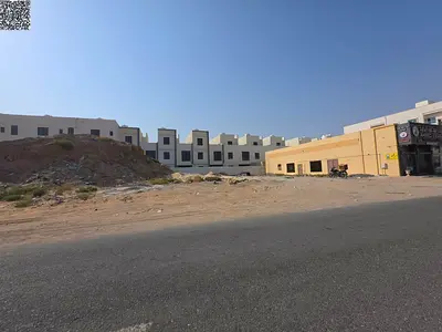 Commercial land for sale on Al Zubair Main Street, 10,000 sq ft, in a prime location in Al Yasmin area.