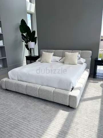 Modern upholstered king-size platform bed with padded headboard