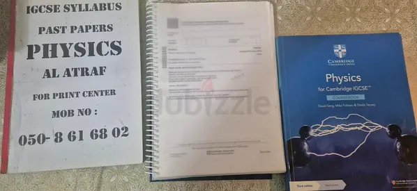 Cambridge IGCSE Physics textbook with printed past papers and notes