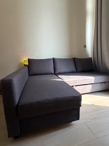 Grey L-shaped fabric sofa - good condition