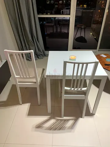 White wooden dining table with 2 matching chairs - compact set