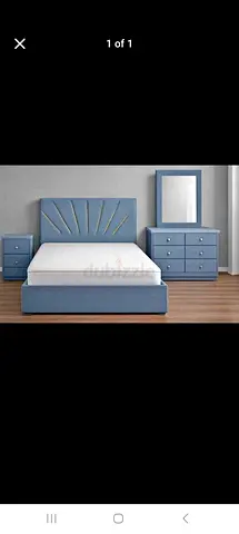 Blue upholstered double bed with matching dresser, mirror and nightstands