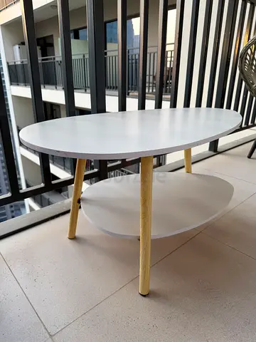 Set of 2 round nesting side tables with white tops and wood legs