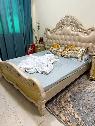 Ornate king-size bed with carved headboard and footboard - good condition