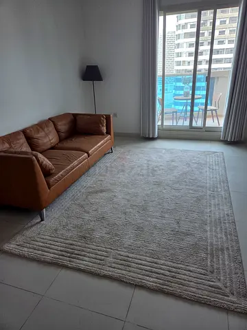 Light beige textured area rug - good used condition (label shown)