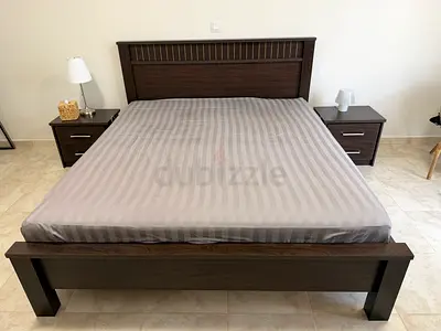 Dark wood bed and bedside table