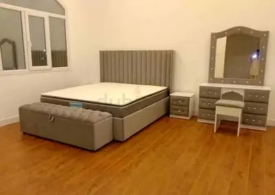 Grey upholstered king bed set with mattress, nightstands and vanity