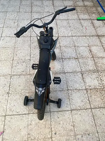 Kids' black balance bike with training wheels — used, good for toddlers