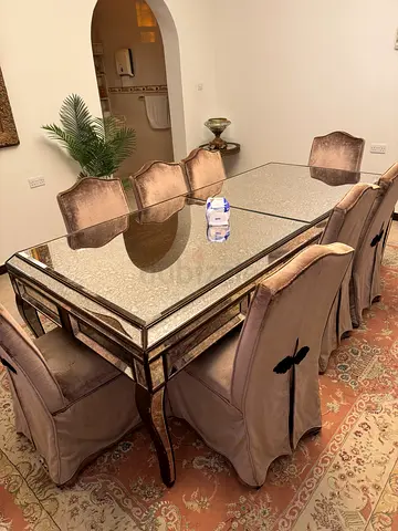 Glass-top dining table with 8 upholstered chairs - good condition