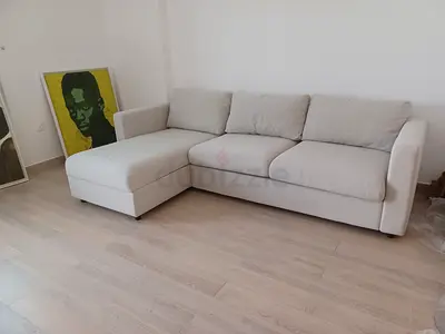 Light beige L-shaped 3-seater sofa bed with chaise