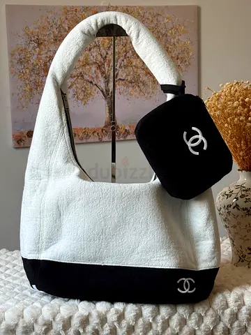 White and black Chanel-style shoulder bag with matching pouch