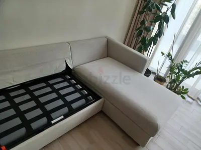Light grey L-shaped sofa bed with chaise and storage — good condition