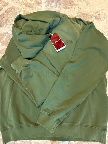 Olive green hoodie, size tag visible, lightly used