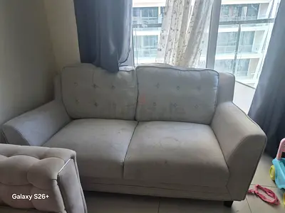 Two-seater light grey fabric sofa - gently used Need clean