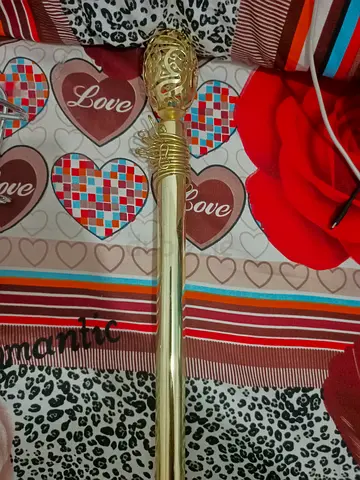 Gold decorative curtain rod with finial -