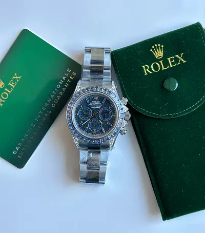 Rolex Cosmograph Daytona 18K white gold, highlighted by a striking blue sapphire baguette cut bezel