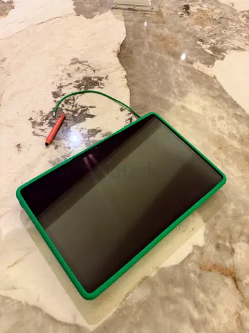 8-inch Android tablet with green silicone case and auxiliary cable