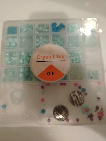 Clear bead organizer box with assorted blue & pink craft beads comes with string