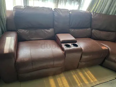 Used Brown leather 7-seater reclining sofa with center console and cup holders