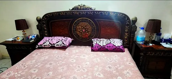 Solid wood king-size bed with matching bedside tables - ornate carved headboard