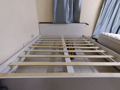 White queen-size wooden bed frame with headboard - good condition
