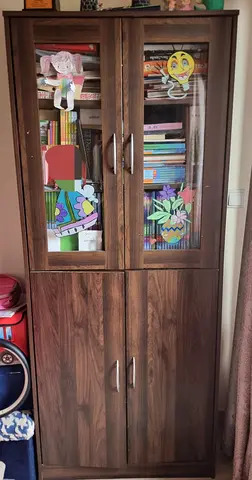 Tall wooden storage cabinet with glass doors - good condition