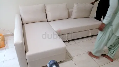Light beige L-shaped sofa bed with chaise, good condition