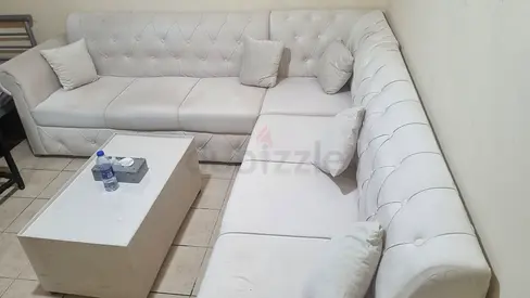 Large L-shaped white tufted sofa set - good condition