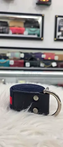 Navy fabric belt with black leather ends and metal D-ring - used