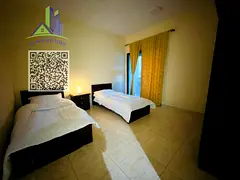 A luxurious, fully furnished two-bedroom apartment with a living room, featuring high-end, brand-new