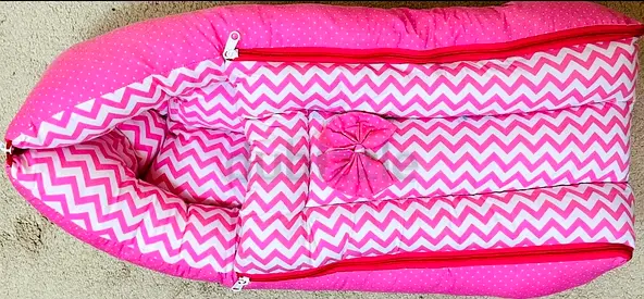 Pink baby nest lounger / portable baby bed with bow detail