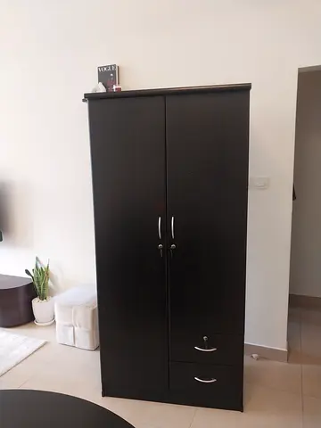 Dark wood tall wardrobe / armoire with drawers - good quality