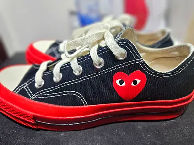 CDG Black canvas low-top sneakers with red sole and heart logo, size uk 4