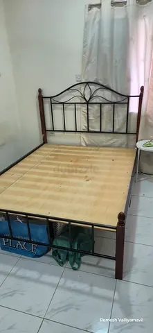 Metal frame double bed with wooden slats - good condition Queen size bed.