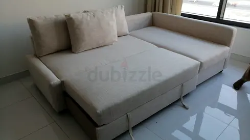 Light beige L-shaped sofa bed with storage - good condition