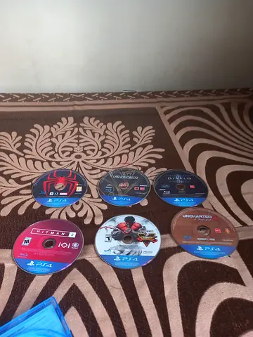 Used PS4 game discs bundle — 7 titles including Uncharted and Hitman
