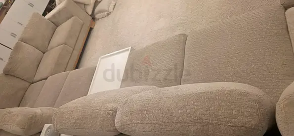 Large beige fabric sectional sofa in good condition