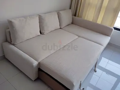 Light beige L-shaped sofa bed, convertible with storage - good condition