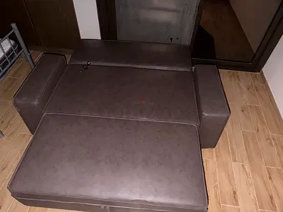 Convertible brown faux-leather sofa bed, good condition