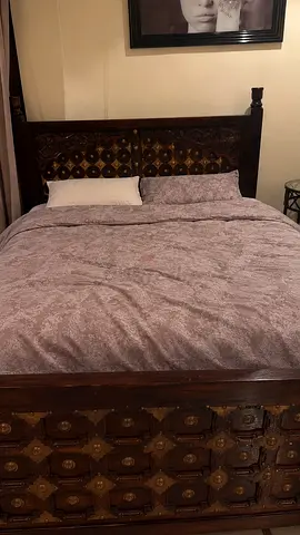 Solid carved wooden queen bed frame with mattress