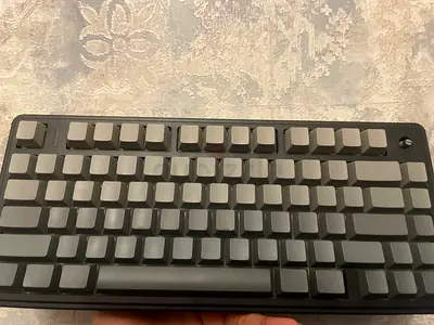 Bare mechanical keyboard PCB with gray blank keycaps (used)