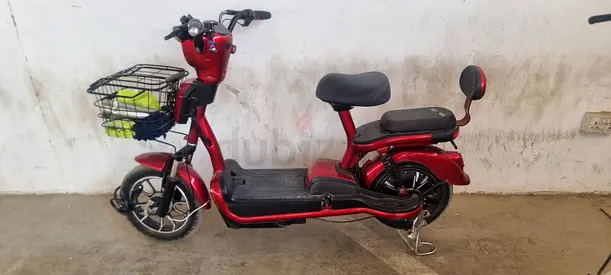 Red Electric Scooter with Rear Seat and Front Basket - Good Condition