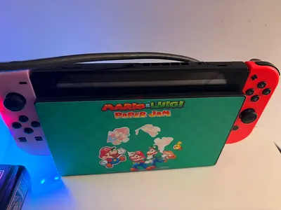 Nintendo Switch 1 console with Joy‑Cons + Mario & Luigi game case (used)