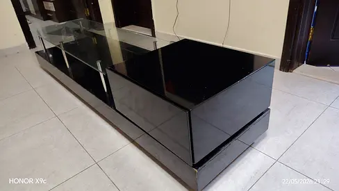 Black high-gloss TV entertainment unit with glass shelves - excellent condition