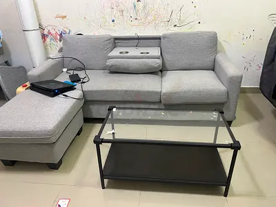Light grey 3-seater sofa with ottoman and glass coffee table - good condition