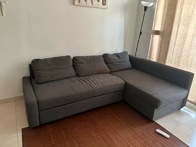 L-shaped grey fabric sofa bed with chaise - good condition
