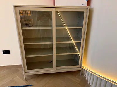 Brand new metal display cabinet with glass sliding doors — good condition