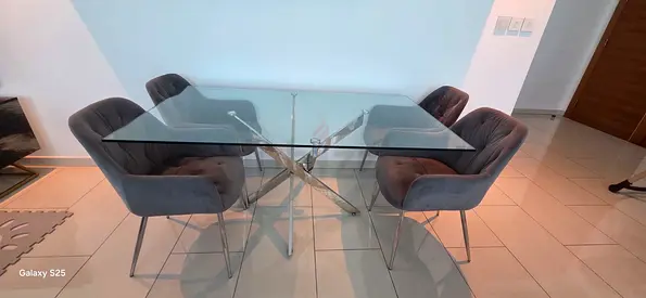 Glass dining table and velvet grey chairs